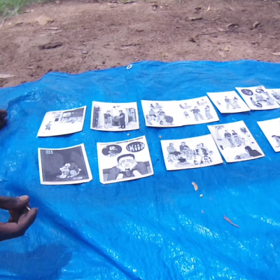 Two young men in Minyerri (faces not shown) participating in a UQ research project (looking at dialectal variation in Kriol)